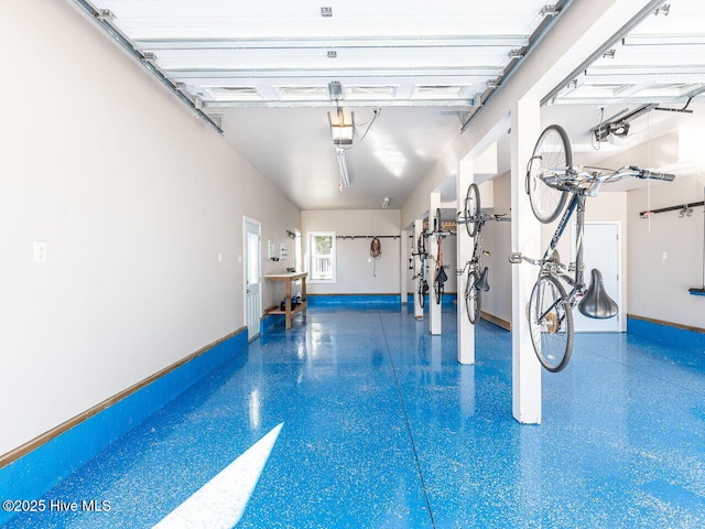 129 Sunset Dr, Cedar Point, NC 28584 - garage with a garage door opener and baseboards