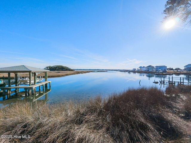 129 Sunset Dr, Cedar Point, NC 28584 - view of dock with boat lift and a water view