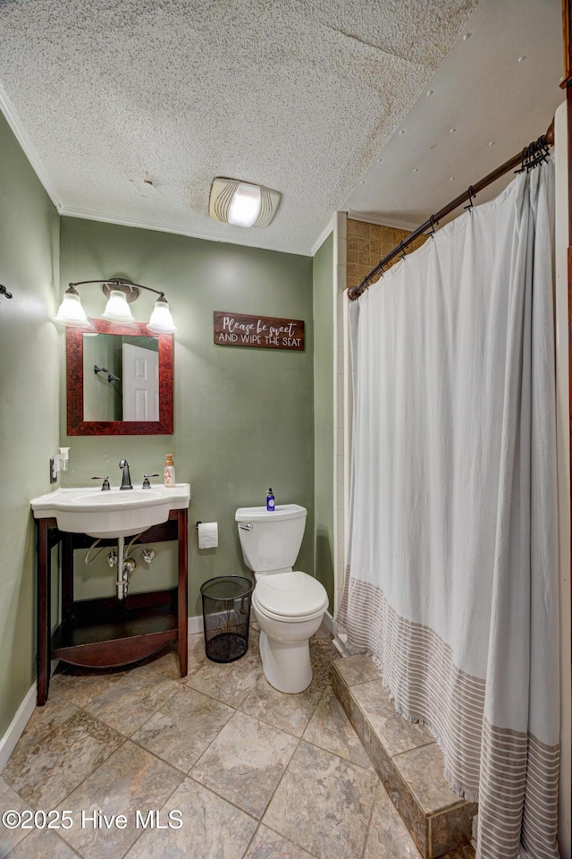 bathroom with curtained shower, toilet, vanity, and a textured ceiling