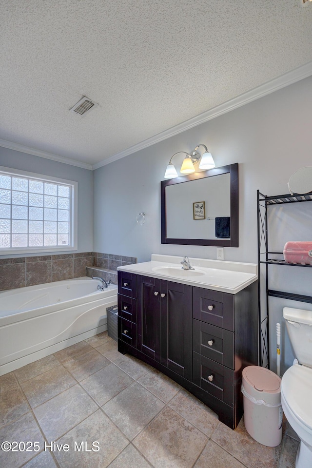 bathroom with visible vents, a textured ceiling, ornamental molding, and vanity