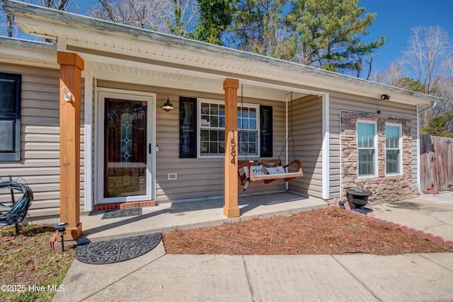 view of exterior entry with a porch