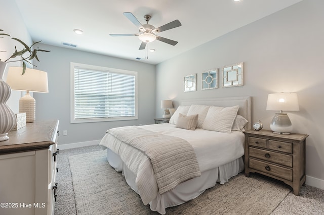 bedroom featuring ceiling fan, light colored carpet, visible vents, and baseboards