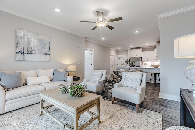 living area featuring a ceiling fan, baseboards, light wood-style flooring, recessed lighting, and crown molding