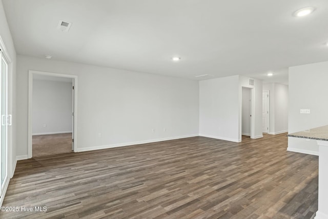 unfurnished living room featuring recessed lighting, visible vents, baseboards, and wood finished floors