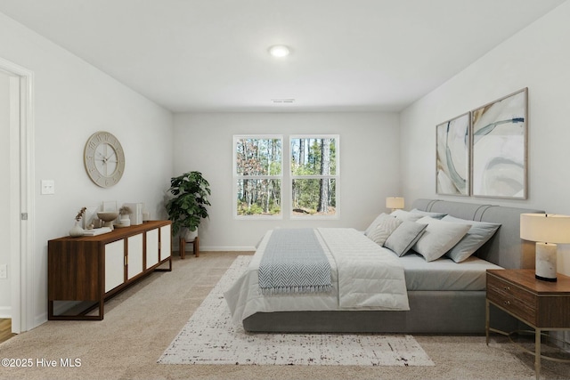 carpeted bedroom featuring visible vents and baseboards