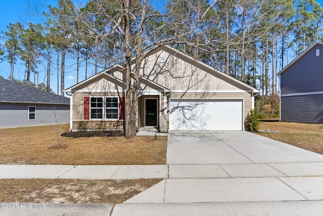 view of front facade with a front lawn, a garage, and driveway