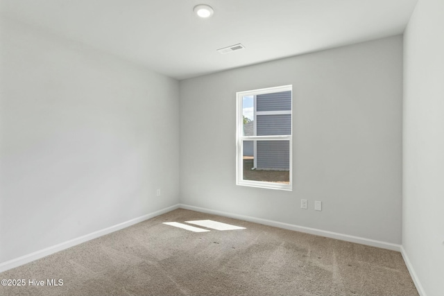 spare room featuring visible vents, baseboards, and carpet