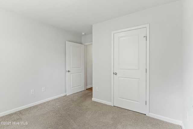 unfurnished bedroom featuring baseboards and carpet floors