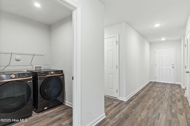 laundry area with baseboards, laundry area, recessed lighting, wood finished floors, and independent washer and dryer