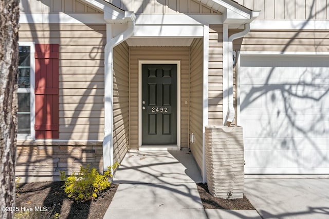 property entrance featuring board and batten siding