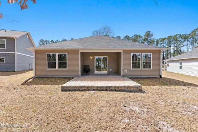 back of property with a patio and a lawn