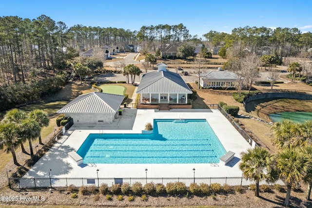 community pool with a patio area, a gazebo, and fence