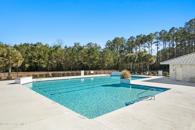 community pool featuring a patio and fence