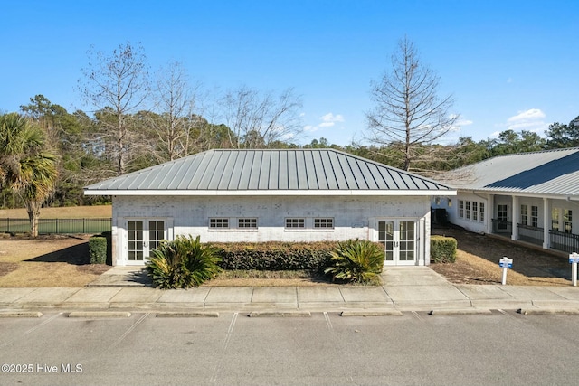 exterior space featuring french doors and fence