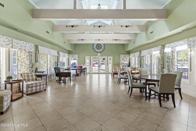 interior space with beam ceiling, visible vents, and light tile patterned floors