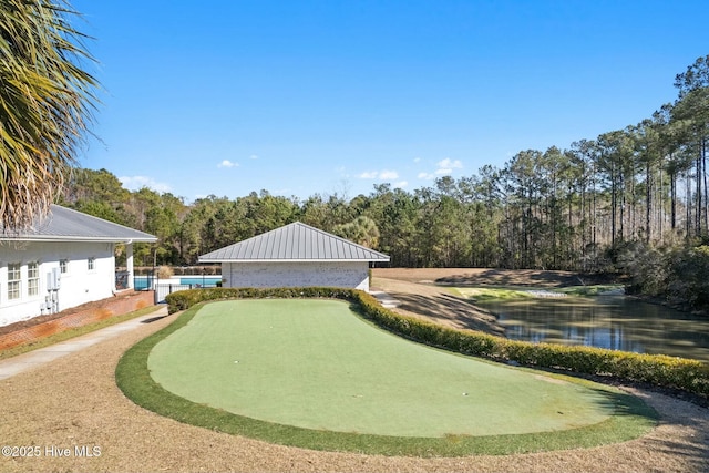 view of home's community featuring a forest view and a water view