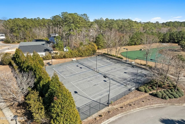 drone / aerial view featuring a view of trees and a water view