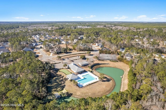 bird's eye view featuring a forest view and a water view