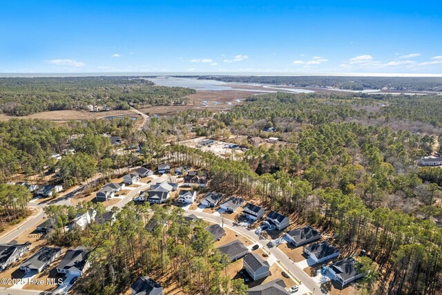 drone / aerial view with a residential view and a view of trees