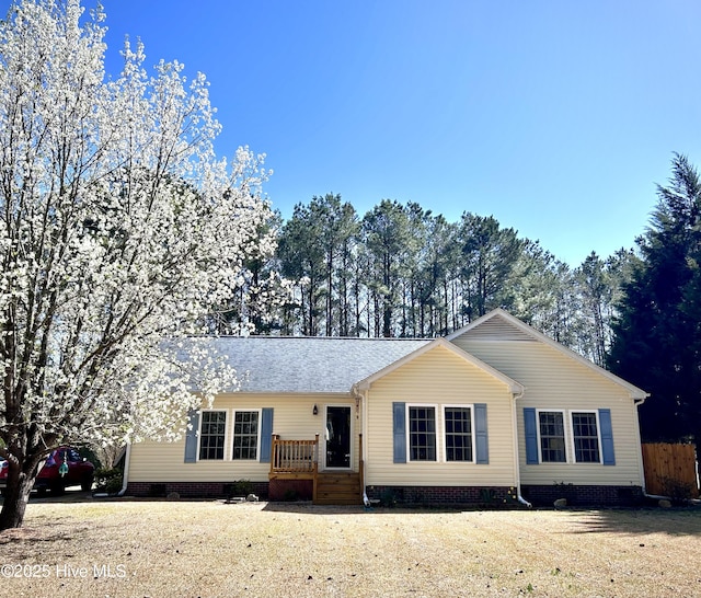 ranch-style home with crawl space and a shingled roof