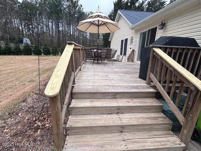 wooden terrace featuring outdoor dining space