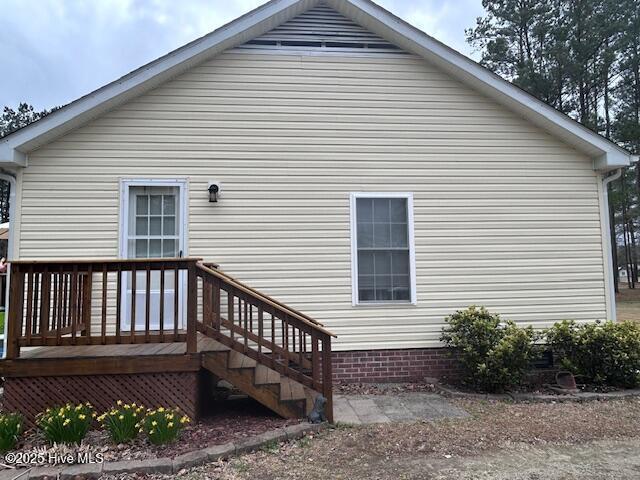 back of property featuring a deck