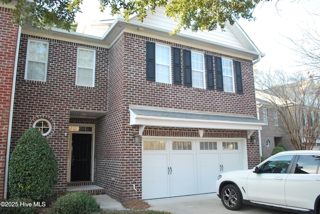 view of front of house featuring concrete driveway, brick siding, and a garage