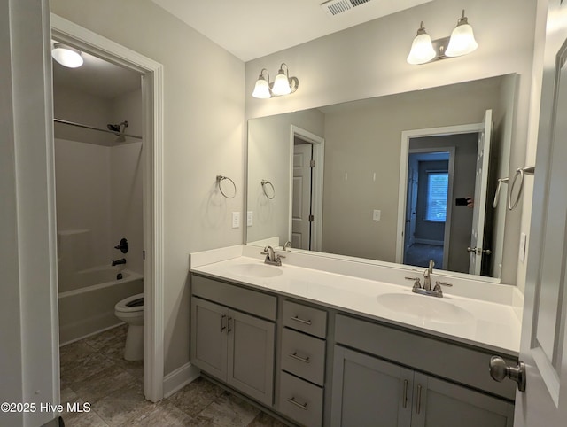 full bath featuring double vanity, toilet, visible vents, and a sink