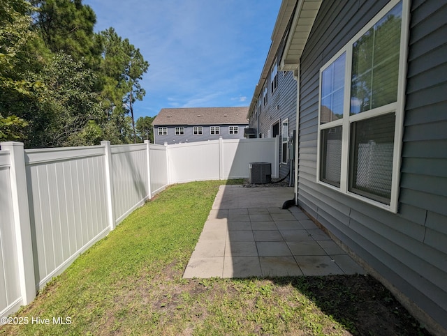 view of yard featuring central air condition unit, a patio, and a fenced backyard