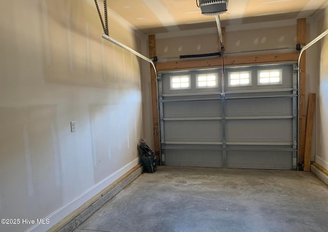 garage with baseboards and a garage door opener