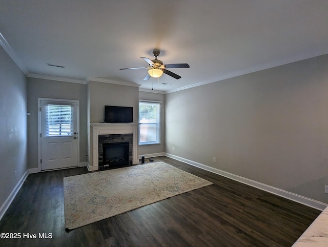 unfurnished living room with dark wood-style floors, a fireplace, crown molding, and baseboards