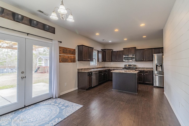 kitchen with a chandelier, visible vents, dark brown cabinets, and stainless steel appliances