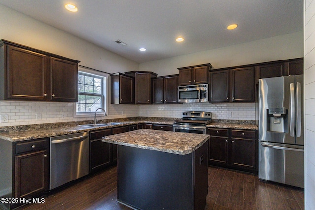 kitchen with visible vents, stainless steel appliances, dark wood-type flooring, and a sink