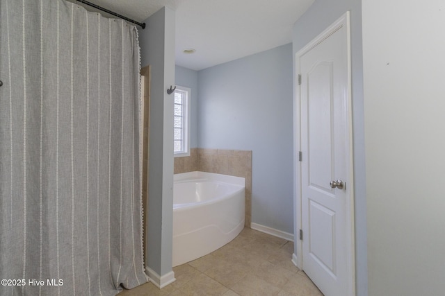 bathroom with a shower with curtain, baseboards, a garden tub, and tile patterned flooring