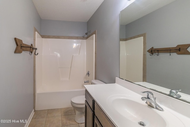 bathroom featuring tile patterned floors, washtub / shower combination, toilet, and vanity