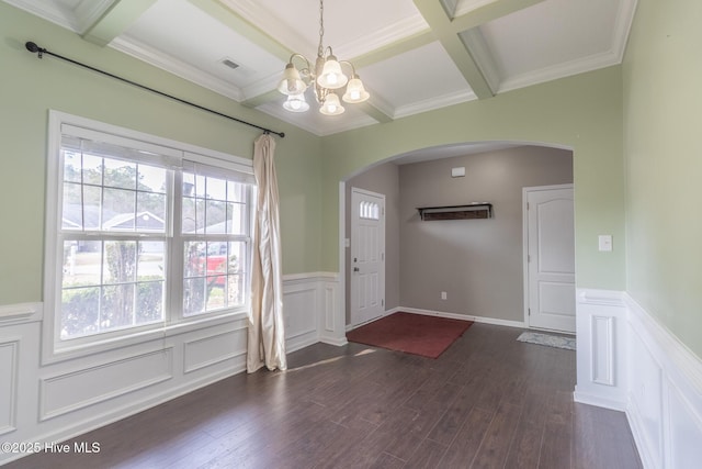 foyer entrance with visible vents, a notable chandelier, coffered ceiling, dark wood-style floors, and arched walkways