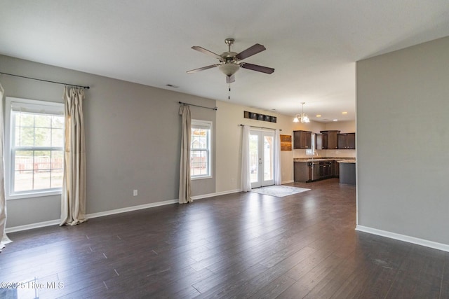 unfurnished living room with visible vents, dark wood-style floors, a ceiling fan, and baseboards