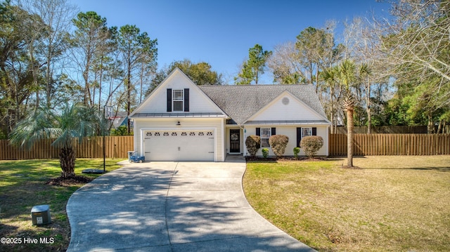 view of front facade with a shingled roof, a front lawn, fence, concrete driveway, and a garage