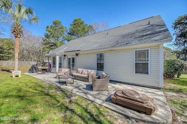 rear view of house featuring an outdoor living space, a shingled roof, fence, a lawn, and a patio