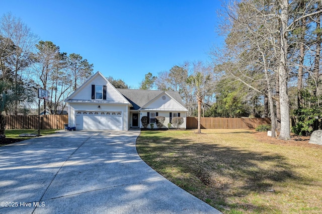 traditional-style house with a garage, concrete driveway, a front yard, and fence