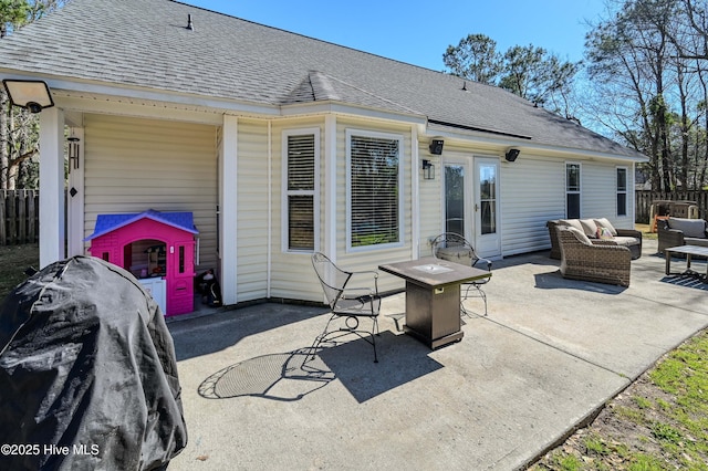 view of patio with an outdoor living space, french doors, and fence