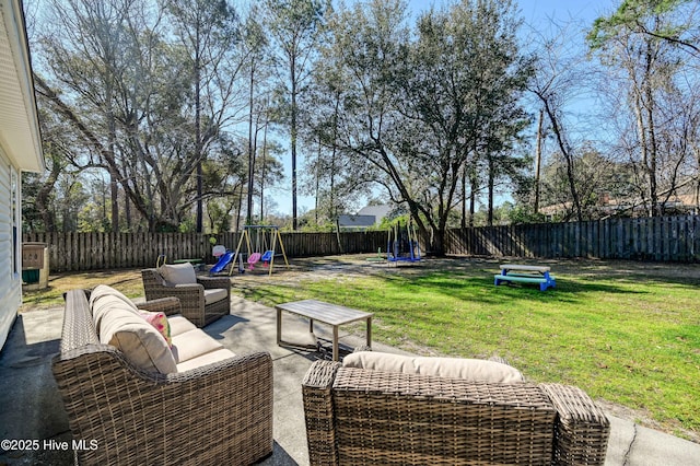 view of patio with a fenced backyard, outdoor lounge area, a playground, and a trampoline