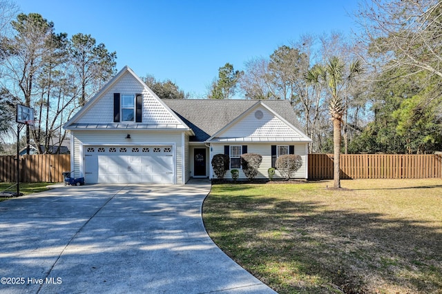 view of front facade with a front yard, roof with shingles, driveway, and fence