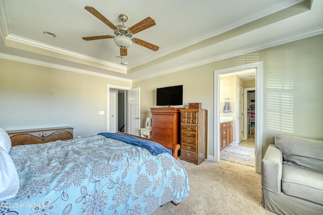 bedroom featuring a tray ceiling, light carpet, ornamental molding, and a ceiling fan