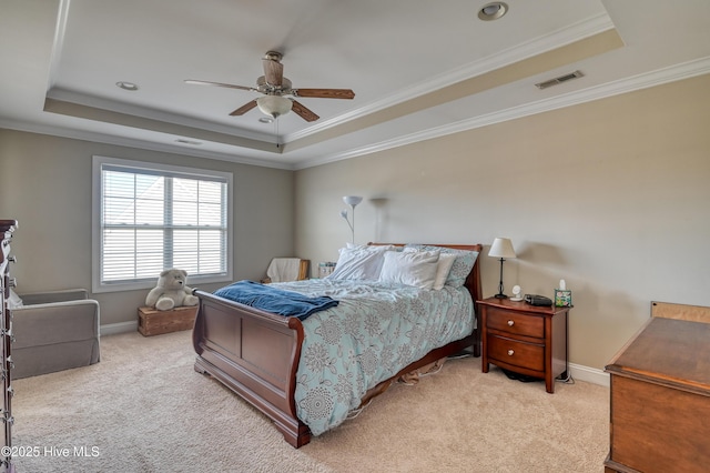 bedroom featuring a raised ceiling, carpet flooring, baseboards, and visible vents