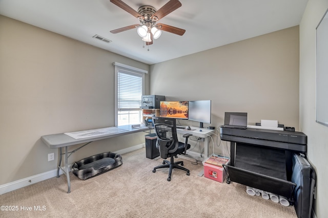 carpeted office space featuring visible vents, baseboards, and a ceiling fan