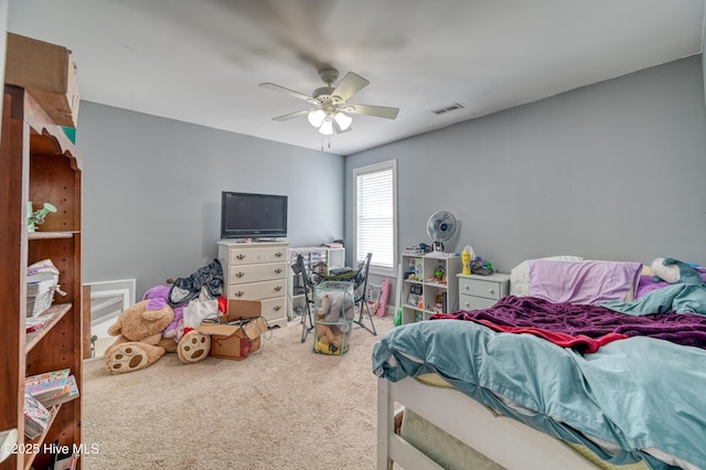 carpeted bedroom with visible vents and a ceiling fan