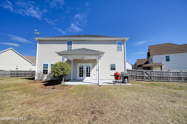 back of house featuring a yard, a fenced backyard, ceiling fan, and a patio