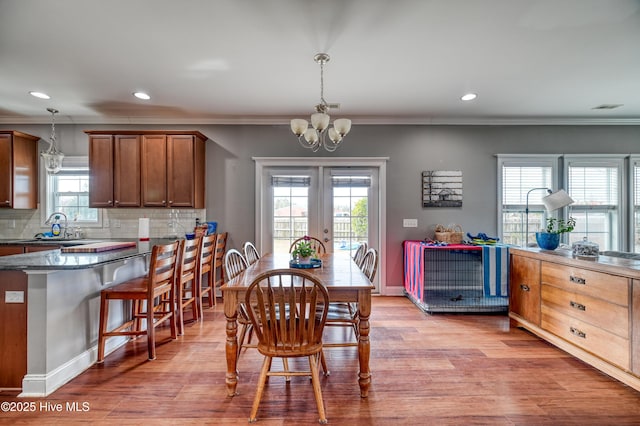 dining area featuring recessed lighting, light wood finished floors, and ornamental molding