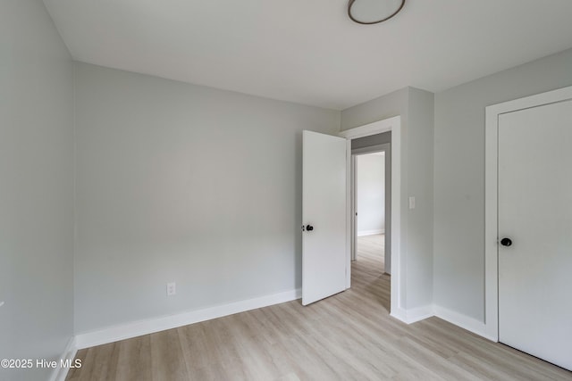 unfurnished bedroom featuring baseboards and wood finished floors